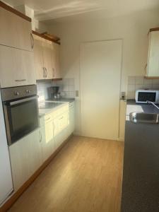 a kitchen with a sink and a stove top oven at Havfruens Lejlighed in Rødby