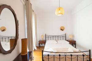 a bedroom with a bed and a large mirror at Casa Dimilia in Sívros