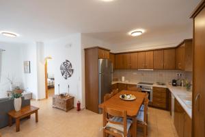 a kitchen with a table and a dining room at Casa Dimilia in Sívros