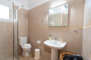 a bathroom with a toilet and a sink and a shower at Casa Dimilia in Sívros +41 photos