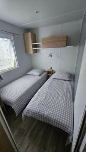 two twin beds in a small room with a window at Eden 1708 in Canet-en-Roussillon +15 photos