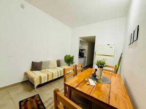 a living room with a wooden table and a couch at Pausa Bragado in Bragado