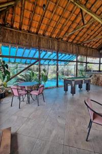 a patio with two ping pong tables and chairs at Pousada Mirante Serra Verde in Carrancas