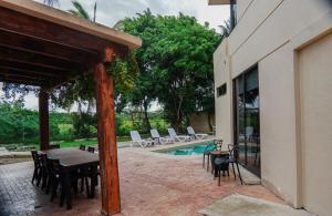 a patio with a table and chairs and a pool at Villa Maraf - Adults Only Boutique Hotel in Cancún