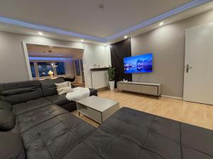 a living room with a couch and a flat screen tv at Rheinperle Wesel in Wesel