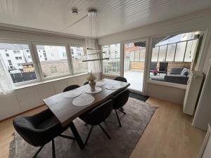 a dining room with a table and some chairs at Rheinperle Wesel in Wesel