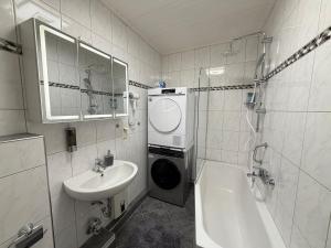 a bathroom with a sink and a toilet and a tub and a sink at Rheinperle Wesel in Wesel +23 photos