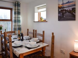 a dining room table with wine bottles and glasses on it at Capstan Cottage in Whitby