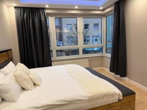 a bedroom with a large bed in front of a window at Rheinperle Wesel in Wesel
