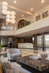 a lobby with a table and chairs in a building at Hotel Jose Antonio in Lima +19 photos