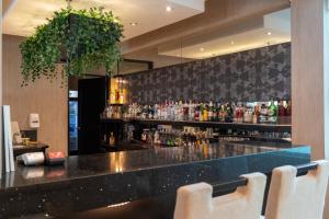 a bar in a restaurant with a bunch of drinks at Hotel Jose Antonio in Lima