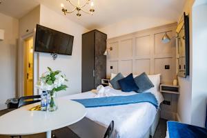 a bedroom with a bed and a table and a tv at Superb Studio With Marina Views- WiFi Included in Dublin