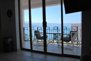 a view of a balcony with a table and chairs at Beachfront view Condo beside la Isla Mall in Puerto Vallarta