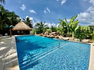 a swimming pool at a resort with a resort at Amazing 2 bedroom condo steps from the beach! in Playa del Carmen +7 photos