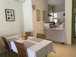 a kitchen with a table with a bowl of fruit on it at Amazing 2 bedroom condo steps from the beach! in Playa del Carmen