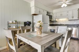 a kitchen with a table with a vase of flowers on it at Ocean-View Balcony! Myrtle Beach 3rd-Floor Retreat in Myrtle Beach