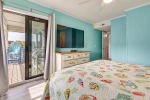a bedroom with a bed and a tv and a balcony at Ocean-View Balcony! Myrtle Beach 3rd-Floor Retreat in Myrtle Beach +23 photos