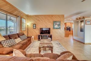 a living room with a couch and a tv at Private Hot Tub & Epic Views in Superstition Mtns! in Apache Junction