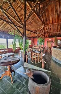 a room with a table and chairs in a building at Pousada Mirante Serra Verde in Carrancas