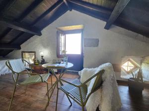 a room with a table and chairs and a window at Ocean View - Nordeste in Feteira Grande