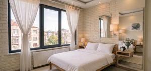 a bedroom with a white bed and a large window at pınar apart hotel in Kapuluören +11 photos