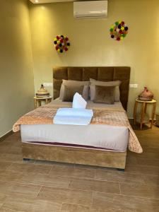 a bedroom with a large bed in a room at Lake House Boulaouane in Douar Annbirat +31 photos