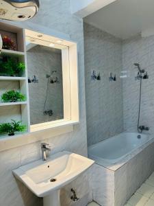 a bathroom with a sink and a bath tub at West Side Résidence in Dakar