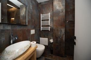 a bathroom with a sink and a toilet at Asinara Guatanamo Belmarsh in Durrës +50 photos