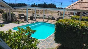 a swimming pool in the middle of a yard at La Posada del Camino in Dina Huapi