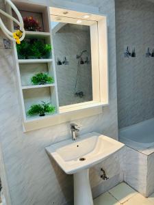 a bathroom with a sink and a mirror at West Side Résidence in Dakar