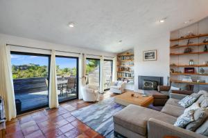 a living room with a couch and a fireplace at Sunset Serenade in Truro