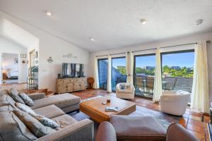 a living room with a couch and a table at Sunset Serenade in Truro