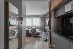 a living room with a bed and a dining room at Lucas by Yoo por LikeHome in Auxiliadora +162 photos