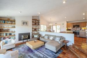 a living room with a couch and a fireplace at Sunset Serenade in Truro