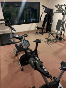 a gym with several exercise bikes and a flat screen tv at Hotel Italiano in Colonia del Sacramento
