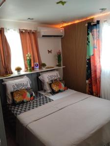 a bedroom with a bed with two pillows on it at Charmant appart in Fort-de-France