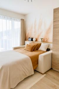 a bedroom with a large bed and a window at Sweet Home - Cocon élégant climatisé, piscine été, balcon & parking privé in Chambéry +19 photos