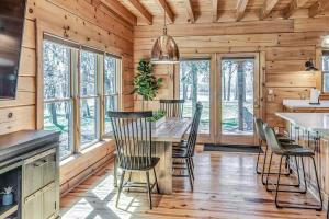 a kitchen and dining room with a table and chairs at Luxury Lakefront Cabin in Castalian Springs