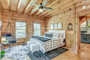 a bedroom with a bed and a ceiling fan at Luxury Lakefront Cabin in Castalian Springs