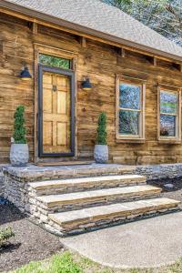 a wooden house with stairs in front of it at Luxury Lakefront Cabin in Castalian Springs +45 photos
