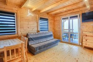 a log cabin with a bed and a table at DOMKI u WILKA - Solina Centrum in Solina