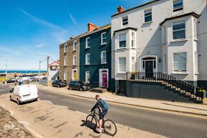 a man riding a bike down a street at Superb Marina Studio- Sleeps 3 in Dublin