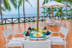 a table with a plate of food and the ocean at Barceló Ixtapa - All Inclusive in Ixtapa