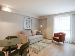a living room with a couch and a table and chairs at Bomma House - Parque 93 in Bogotá +67 photos