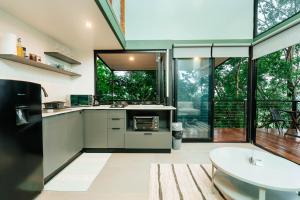a kitchen with a large window and a sink at Stylish Tiny Home with Sea View and Bathtub in Alto del Espino Prieto