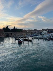a dock with a boat in a body of water at Calle Boldu Venice in Venice