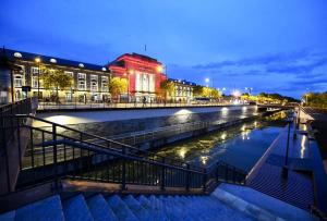 a river in a city at night with buildings at Au Petit Colombage - Cosy au centre de Mulhouse - Gare proche in Mulhouse