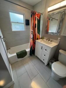 a bathroom with a sink and a toilet and a shower at The Brookline Retreat in Pittsburgh +7 photos
