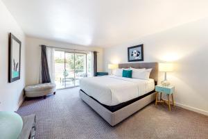 a bedroom with a large bed and a window at Desert Retreat in Indian Wells