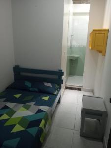 a bedroom with a bed and a bathroom with a shower at Hotel Danubio Azul in Yopal